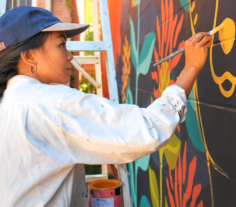 Artist painting a wall mural